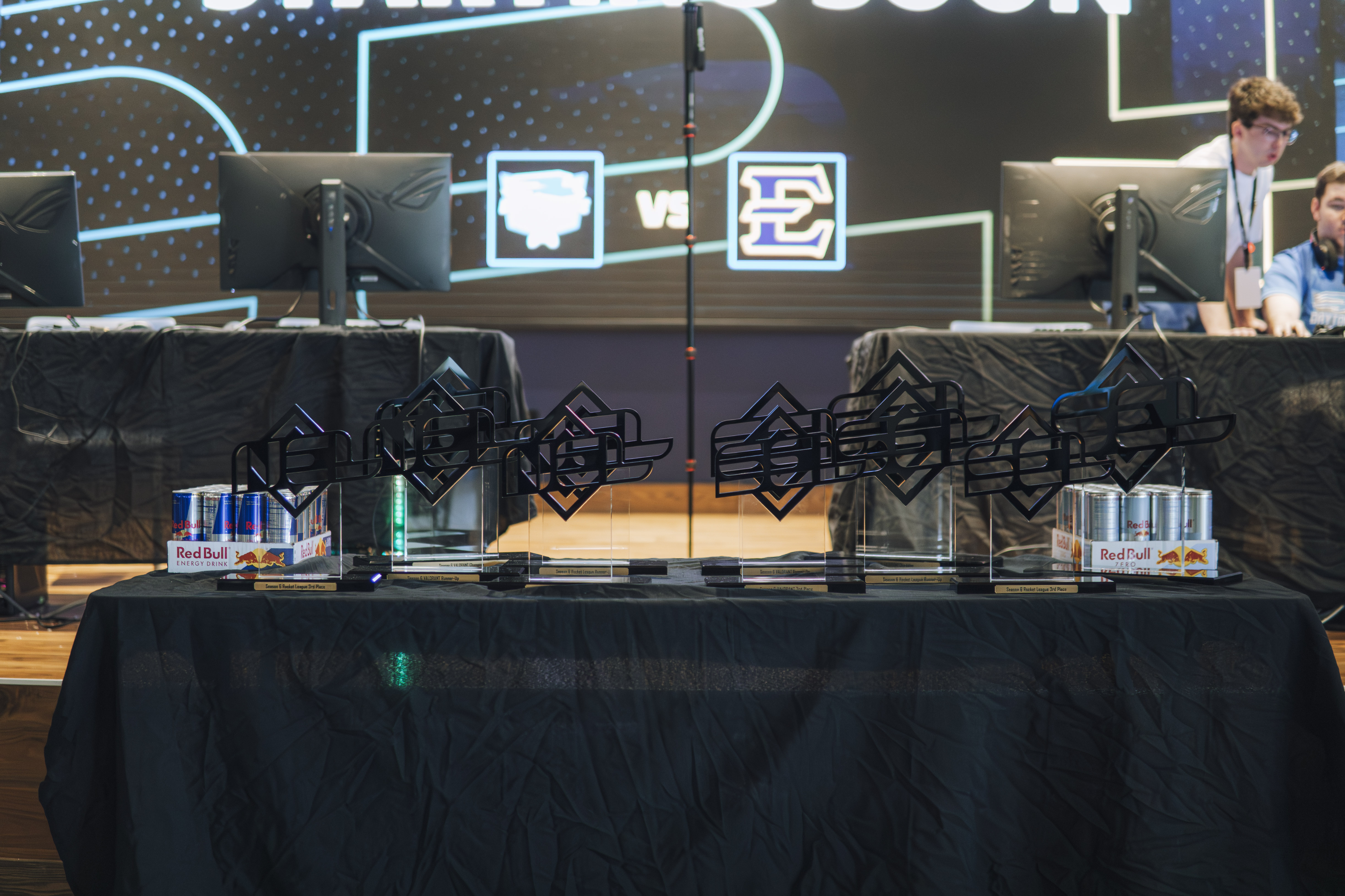 Custom SEL and NEL championship trophies on a finals table